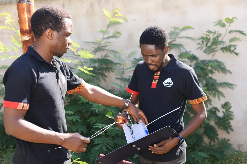 Two members in the field installing the monitor